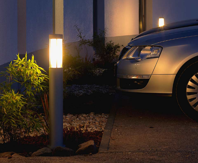 An outdoor light illuminates a parking lot.