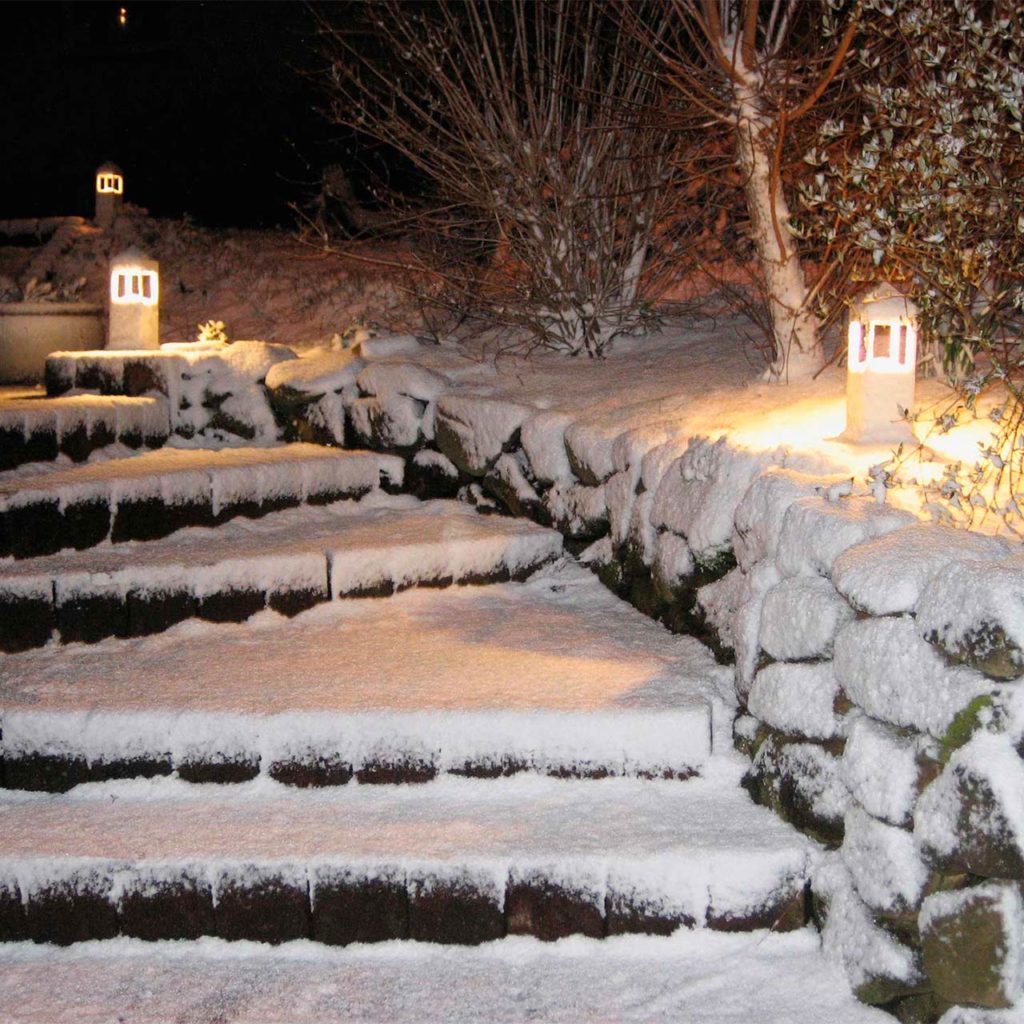 A winter snowed-in staircase illuminated with Albert bollard lights.