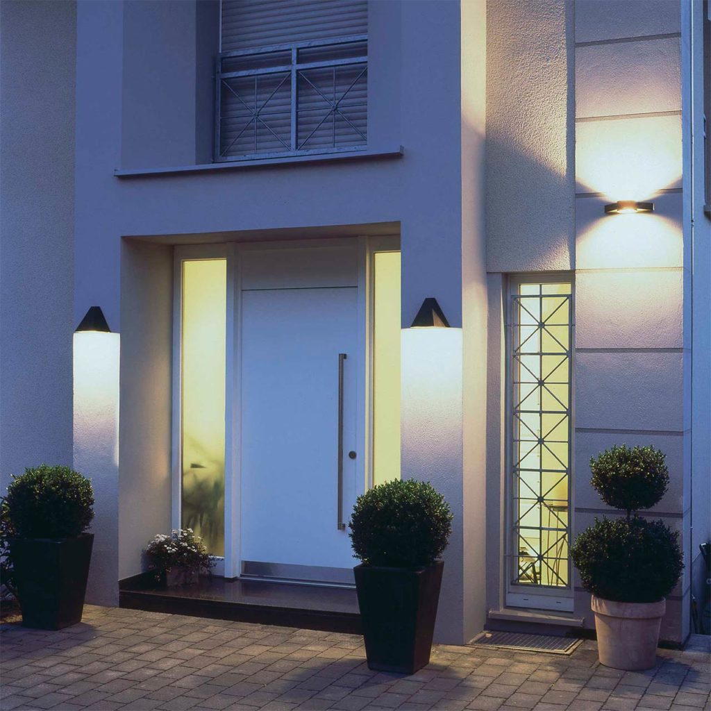 An ensemble of entrance luminaires provides light and safety at a modern house entrance.
